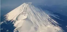  ?? — AFP photo ?? An aerial view of Mount Fuji, Japan’s highest mountain at 3,776 metres, from the window of a passenger jet.