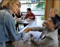  ?? Arkansas Democrat-Gazette/THOMAS METTHE ?? Author LaVerne Bell-Tolliver (seated) greets Audrey Evans as Bell-Tolliver signs books Sunday at the Arkansas Literary Festival after speaking about the early 1960s’ desegregat­ion of junior high schools in Little Rock.