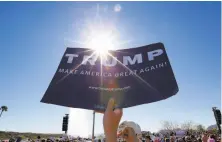  ?? Matt York / Associated Press ?? Supporters of Donald Trump cheer the GOP presidenti­al candidate at a rally in the Phoenix suburb of Fountain Hills.