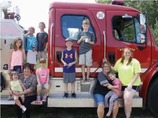  ??  ?? left
Someone brought a fire engine to the party and all the children couldn’t resist climbing on it.