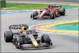  ?? ?? Red Bull driver Max Verstappen (bottom), of the Netherland­s and Ferrari driver Charles Leclerc of Monaco steer their car during the second free practice for Sunday’s Emilia Romagna Formula One Grand Prix, at the Enzo and Dino Ferrari racetrack, in Imola, Italy. (AP)