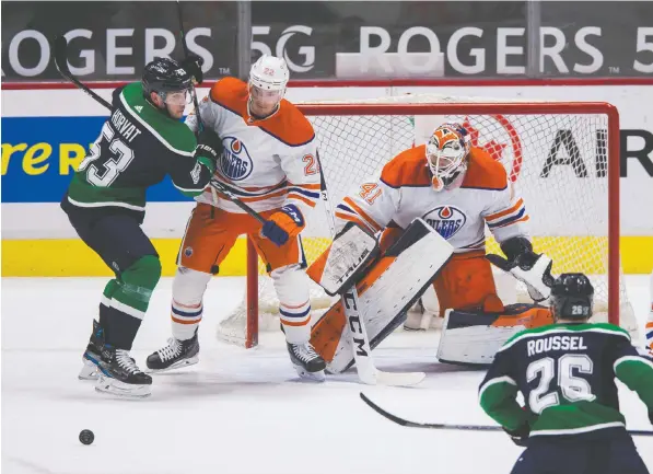  ?? — USA TODAY SPORTS ?? Oilers goalie Mike Smith, in action against the Vancouver Canucks, has a 2.36 goals-against average, .922 save percentage, and a 15-4-2 record in 23 games with three shutouts. Coach Dave Tippet calls him `one of the best athletes I've ever coached.'