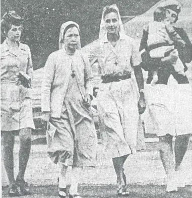  ?? SISTER SHEILA O’TOOLE ?? Sister Sheila O’toole, third from left, pictured, with Sister M Lea, second from left, after escaping the unrest in Vietnam and landing in Auckland. They are accompanie­d by two New Zealand servicewom­en – and the “first Vietnamese orphan to arrive in New Zealand”.