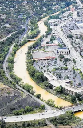  ?? Jerry McBride
The Durango Herald ?? THE POPULAR Animas River in Colorado is yellowed by contaminat­ion after a million gallons of water from a defunct gold mine spilled into the waterway.