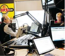  ?? Leah Hennel/Calgary Herald ?? The Coach and Joanne, during their first morning show back together after four and a half years apart at XL 103 studios, Monday.