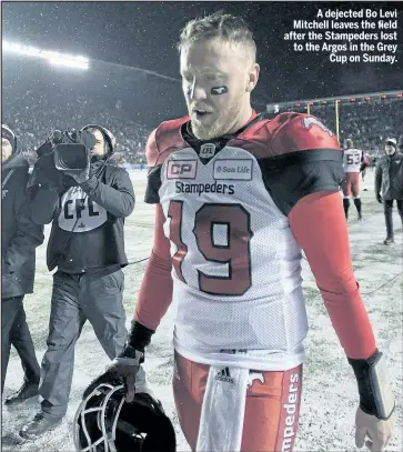  ?? THE CANADIAN PRESS ?? A dejected Bo Levi Mitchell leaves the field after the Stampeders lost to the Argos in the Grey Cup on Sunday.