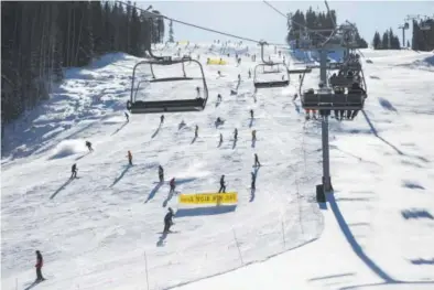  ??  ?? nov. 25: Skiers and riders go down the Born Free run on Vail’s opening day.