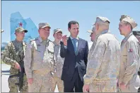  ?? AP PHOTO ?? In this photo released on the official Facebook page of the Syrian Presidency, Syrian President Bashar Assad inspects with the Russian Army’s Chief of Staff, Gen. Valery Gerasimov, the Russian Hmeimim air base in the province of Latakia, Syria, Tuesday.