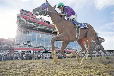  ?? ASSOCIATED PRESS ?? MATT SLOCUM California Chrome, with jockey Victor Espinoza aboard, gallops across the finish line to win the Preakness Stakes, outrunning a late bid by Ride On Curlin.