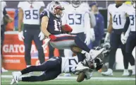  ?? Charles Krupa / Associated Press ?? Titans cornerback Adoree’ Jackson tackles Patriots wide receiver Julian Edelman in the a wild-card playoff game in 2020 in Foxborough, Mass.