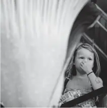  ??  ?? Bea Waugh, 5, plugs her nose as she and her little sister, Annie, 1, take in the glory — and the rancid smell — of the corpse flower on Friday.