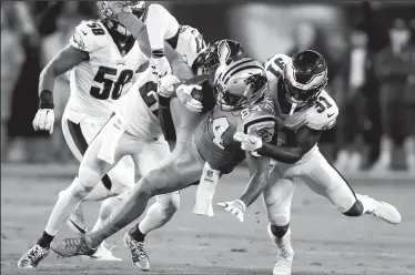  ?? YONG KIM/TRIBUNE NEWS SERVICE ?? Philadelph­ia Eagles cornerback Jalen Mills, right, and strong safety Malcolm Jenkins stop Carolina Panthers tight end Ed Dickson (84) in Charlotte, N.C., on Thursday.