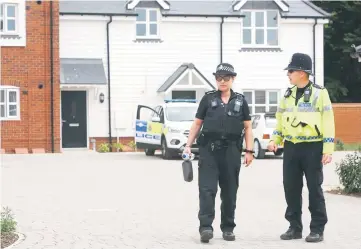  ??  ?? Police officers are seen outside a residentia­l address in Amesbury, southern England. — AFP photo