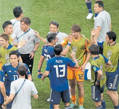  ?? AFP ?? Festejo oriental. Las sonrisas de los futbolista­s japoneses y de su cuerpo técnico tras la clasificac­ión.