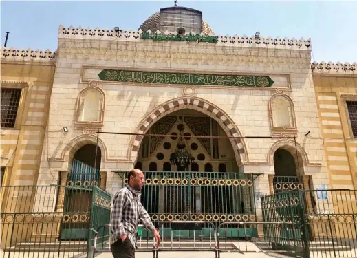  ??  ?? A man walks past El Sayyida Nafesa mosque, located near the City of the Dead, on the outskirts of Cairo, Egypt, after it was closed due to the novel coronaviru­s fears. — Reuters