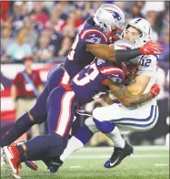  ?? Adam Glanzman / Getty Images ?? The Colts’ Andrew Luck is sacked by the Patriots’ Trey Flowers (98) and Patrick Chung (23) during Thursday’s game in Foxborough, Mass.