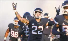  ?? Stephen Dunn / Associated Press ?? Connecticu­t linebacker Eli Thomas (22) raises his arms to the crowd as his team enters the field for their 2018 season opener at Rentschler Field.