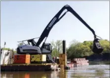  ??  ?? Crews perform dredging work along the upper Hudson River in Waterford in May 2015.