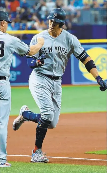  ?? GETTY ?? Aaron Judge is congratula­ted after hitting a solo home run in the first inning last night.