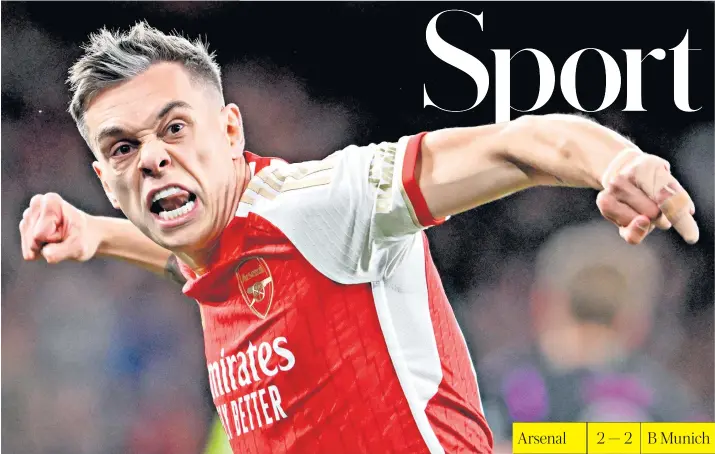  ?? ?? Delight: Leandro Trossard celebrates bringing Arsenal level in the first leg of their Champions League tie, but the hosts were lucky not to concede a penalty after a bizarre Gabriel Magalhaes handball (below)