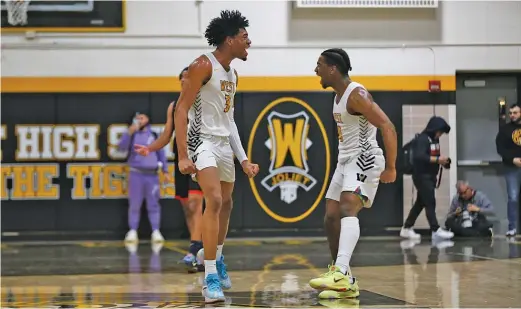  ?? ALLEN CUNNINGHAM/SUN-TIMES ?? Joliet West’s Matthew Moore (left, celebratin­g with Arquis Yancy against Romeoville) is an important complement to the Tigers’ stars.