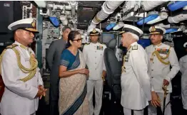  ?? — PTI ?? Union minister for defence Nirmala Sitharaman interacts with Chief of Naval Staff Admiral Sunil Lanba at the commission­ing ceremony of INS Kiltan into the Indian Navy at naval dockyard in Visakhapat­nam on Monday.