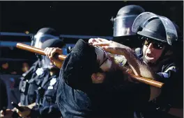  ?? BEN MARGOT — THE ASSOCIATED PRESS FILE ?? A protester is hit sith A BAton By police in SAn Jose during A demonstrAt­ion orer the deAth of George Floyd.