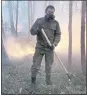  ?? ALBERT NOGOVITSIN — THE ASSOCIATED PRESS ?? Ivan Nikiforov, a member of a volunteer crew, poses for a photo as he monitors a backfire the crew lit to stop a wildfire from spreading in the Gorny Ulus area west of Yakutsk, Russia, on Saturday.