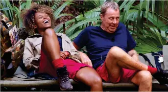  ??  ?? Easygoing: Campmate Fleur East teaches ‘MC Hazza’ some street slang, and, right, Harry tucks into grubs during Bushtucker Trial