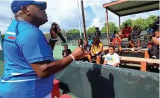  ?? (Pine Bluff Commercial/Eplunus Colvin) ?? Tennis instructor Kreth Simmons (left) gives Pine Bluff Parks & Recreation participan­ts a pep talk during their water break at the first-annual tennis camp at the Bloom Tennis Center.