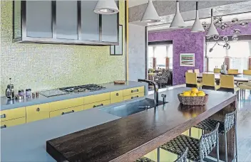  ?? MARCO RICCA DRAKE/ANDERSON VIA AP ?? A kitchen in New York designed by Manhattan-based firm Drake/Anderson. They created this Tribeca kitchen to flow seamlessly into the main living space, by repeating touches of colour throughout, echoing the mosaic backsplash pattern in the chair...