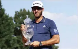  ??  ?? Winner! Dustin Johnson con su trofeo de campeón del FedEx St. Jude Classic, tras hacer un eagle que le dio el triunfo en el hoyo 18.