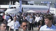  ?? MICHEL EULER — THE ASSOCIATED PRESS FILE ?? Visitors walk by a Falcon 10X prototype by the French manufactur­er Dassault Aviation onwednesda­y at the Paris Air Show in Le Bourget, France. Airlines are facing increasing pressure to cut their climate- changing emissions; thatmade sustainabl­e aviation fuel a hot topic this week at the air show.