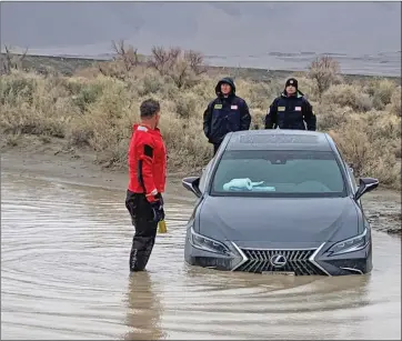  ?? Photo courtesy of the Inyo County Sheriff’s Office ?? The Inyo County Sheriff’s Office reported that on Sunday the Office of Emergency Service’s Swiftwater Taskforce assisted a stranded motorist in a shallow water crossing near the Tinnemeha area. According to the report, the motorist was on a fishing expedition. The ICSO reminds the public that many roads throughout Inyo County have sustained serious flood damage and all waterways are running “full and fast.” The Owens River has significan­t undercut banks and “is not safe.”