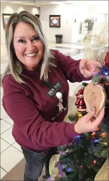  ?? SUBMITTED ?? Brandi Ford puts the finishing touches on the tree that John 3:17 Ministry will enter into the traditiona­l category of the Festival of Trees contest, hosted by the Newport Area Chamber of Commerce.