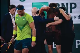  ?? CHRISTOPHE ENA/ASSOCIATED PRESS ?? Germany’s Alexander Zverev is carried off the court Friday during his French Open semifinal against Rafael Nadal. Zverev’s ankle injury forced him to default.