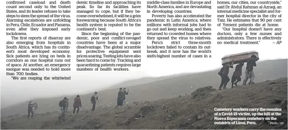  ?? Photo / AP ?? Cemetery workers carry the remains of a Covid-19 victim, up the hill at the Nueva Esperanza cemetery on the outskirts of Lima, Peru.