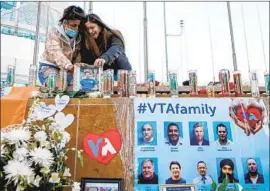  ??  ?? Amy Osborne AFP/Getty Images MOURNERS visit a memorial for the victims of the mass shooting in San Jose.