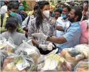  ?? PTI ?? World badminton champion P.V Sindhu distribute­s essential items in Hyderabad on Monday. —