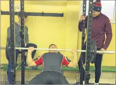  ??  ?? Castlelyon­s and Imokilly star, Aidan O’Sullivan assisted in some power lifting by Darragh Lawlor and Eoin Maye in the temporary club gym.