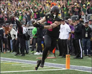  ?? Chris Pietsch The Associated Press ?? Oregon receiver Terrance Ferguson hauls in one of Bo Nix’s five touchdown passes Saturday during the Ducks’ 45-30 victory in Eugene, Ore.