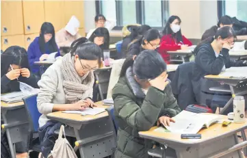  ??  ?? Students prepare to take the annual College Scholastic Ability Test, a standardis­ed exam for college entrance, at a high school in Seoul. — AFP photo