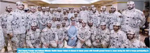  ??  ?? First Deputy Premier and Defense Minister Sheikh Nasser Sabah Al-Ahmad Al-Sabah poses with Kuwaiti ground forces in Jazan during his visit to troops participat­ing in the Restoratio­n of Hope Operation.