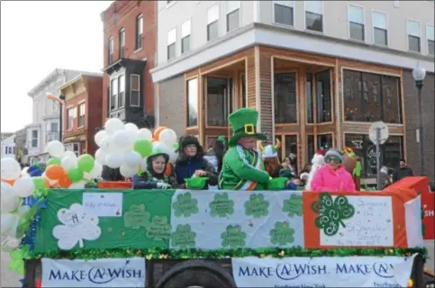  ?? NICHOLAS BUONANNO- NBUONANNO@TROYRECORD.COM ?? The Hoosick Falls St. Patrick’s Day parade first-ever Junior Grand Marshal, 10-year-old Hoosick Falls resident Luke Hoag,center, throws candy out to other kids during the parade Saturday while dressed in a St. Patrick’s Day hat and other green attire.