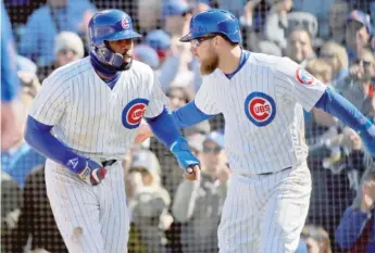  ?? GETTY IMAGES ?? Teammate Ben Zobrist ( right, with Heyward) says the ball is coming off Heyward’s bat ‘‘ very, very loud.’’