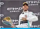  ?? — AFP ?? ABU DHABI: Mercedes’ British driver Lewis Hamilton celebrates his win at the Yas Marina Circuit in Abu Dhabi, after the final race of the Formula One Grand Prix season, yesterday.
