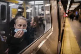  ?? JOHN MINCHILLO — THE ASSOCIATED PRESS FILE ?? A passenger looks out onto the platform while riding a northbound subway train at the 36th Street subway station in New York City, the site of a shooting attack.