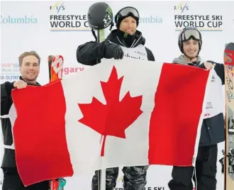  ?? Jeff Mcintosh/the Canadian Press ?? Canada’s Justin Dorey, centre, celebrates his victory with second place finisher and teammate Noah Bowman, right, and third place finisher Matt Margetts following the World Cup event in Calgary, Friday.