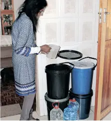  ?? | SIBONELO NGCOBO ?? MARRIAMAH Govender has to fill water from the Jojo tanks into buckets and carry it to her home a few meters away.