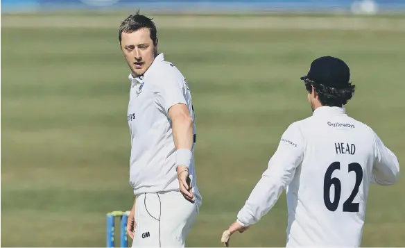  ??  ?? Sussex’s Ollie Robinson, left, celebrates with team-mate Travis Head after taking a wicket.